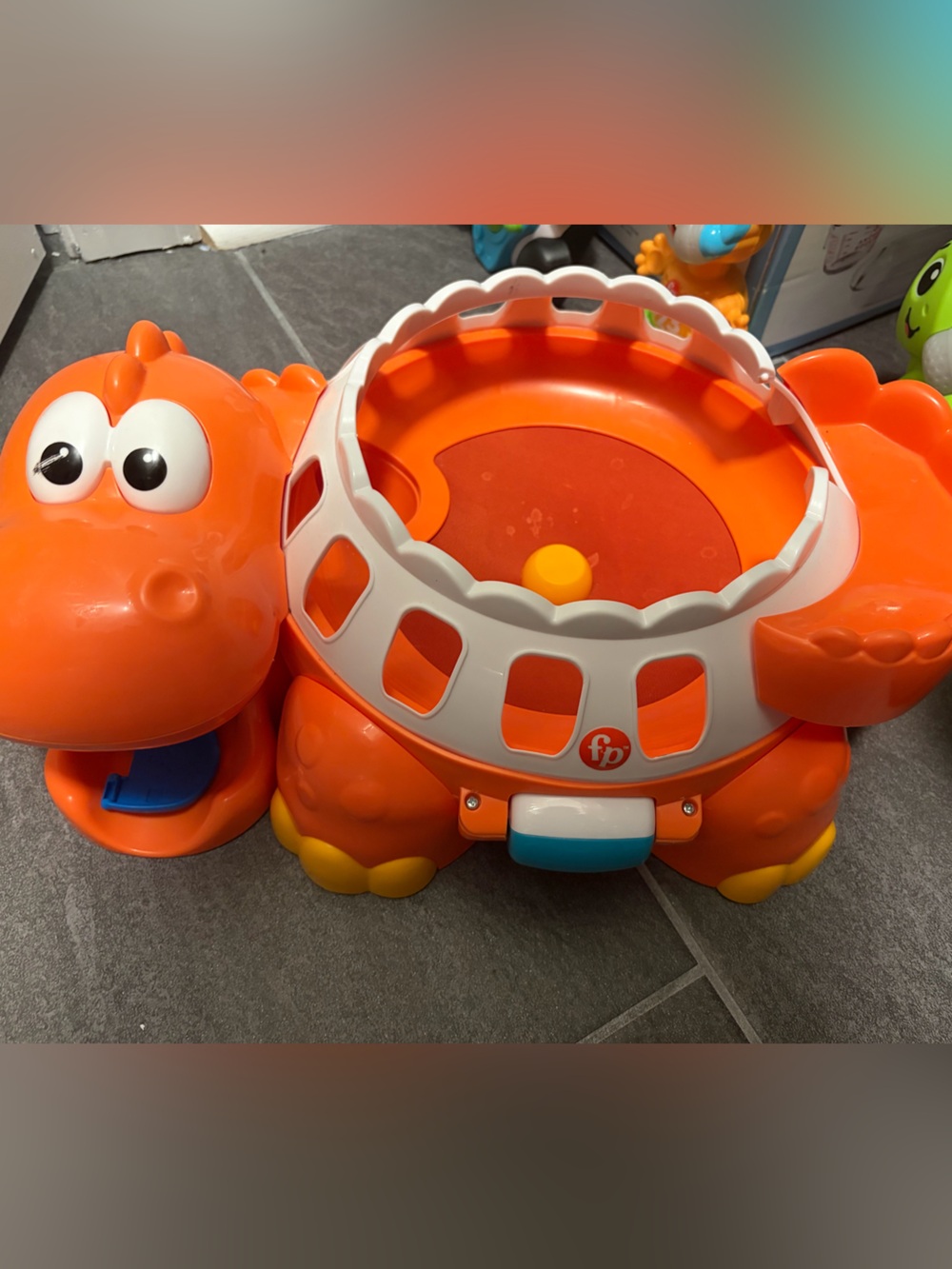 Fisher-Price Orange Dinosaur Spin Drum Toy with White Accents